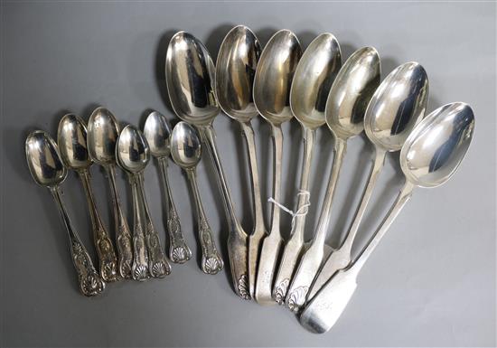 Three William IV silver fiddle, thread and shell table spoons, four later fiddle pattern tablespoons & seven assorted teaspoons
